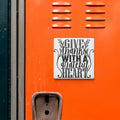 a vibrant orange wall with a white sign that reads "Give thanks with a grateful heart".