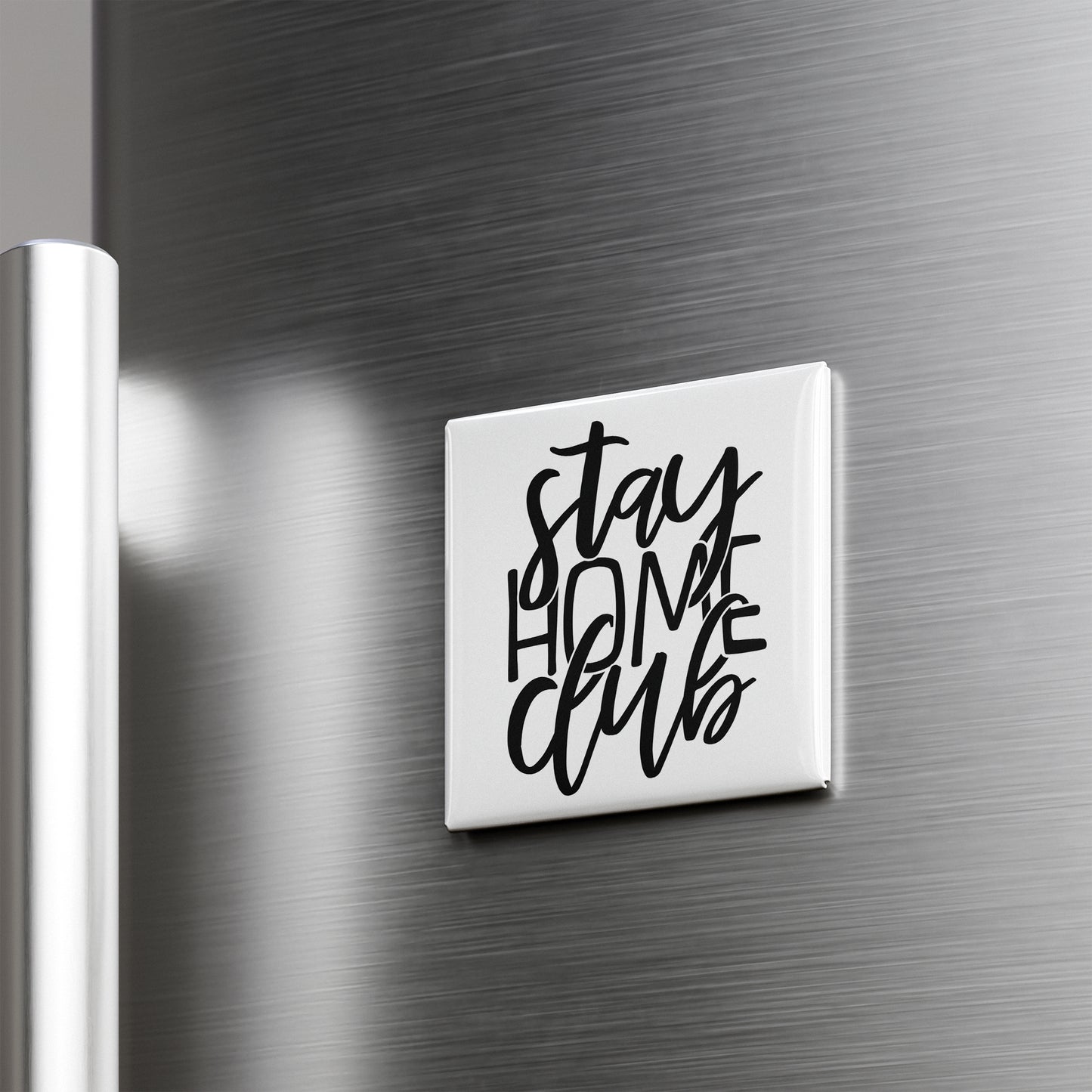 A white square magnet with the text "STAY HOME CLUB" written in a stylized font.