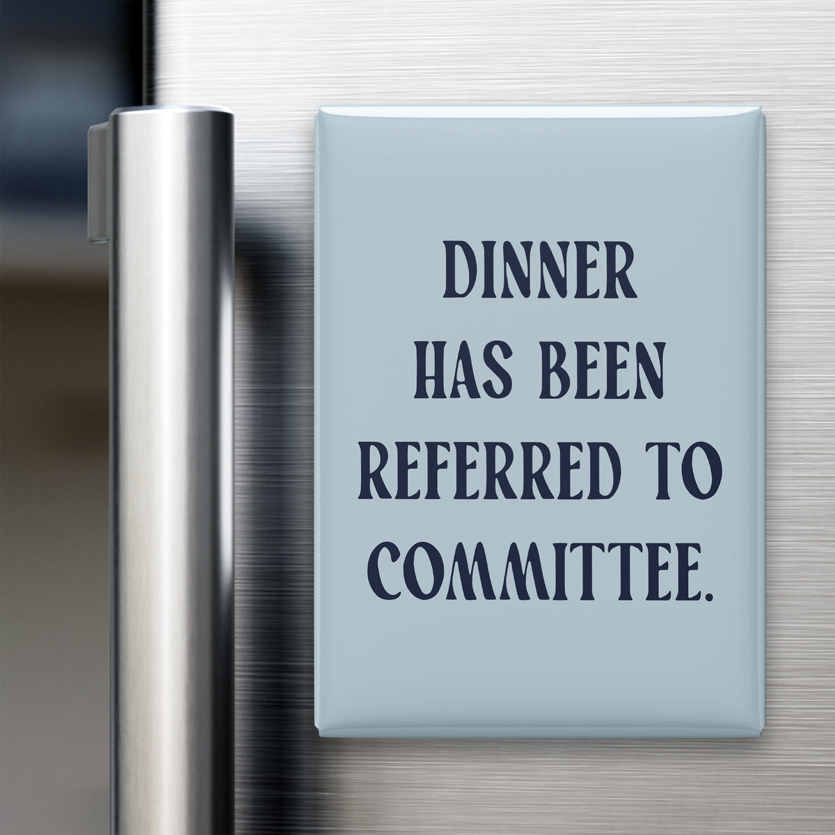 “Dinner has been referred to committee.” quote magnet displayed on a refrigerator