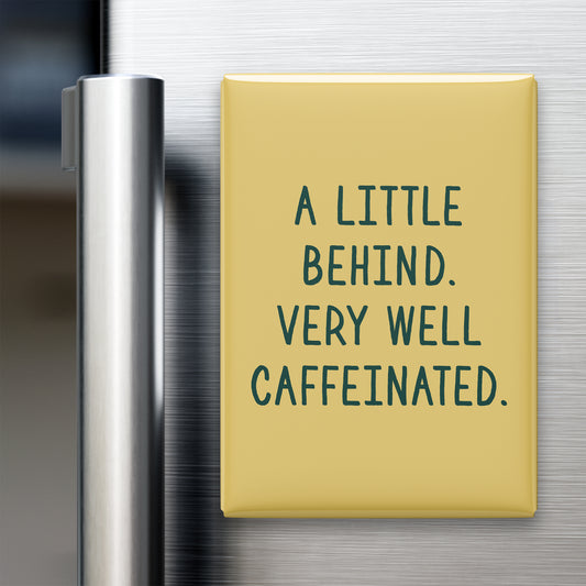 “A little behind. Very well caffeinated.” quote magnet displayed on a refrigerator