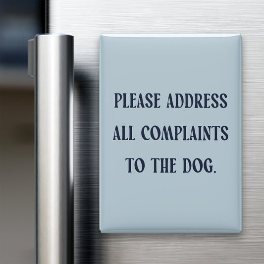 “Please address all complaints to the dog.” quote magnet displayed on a refrigerator