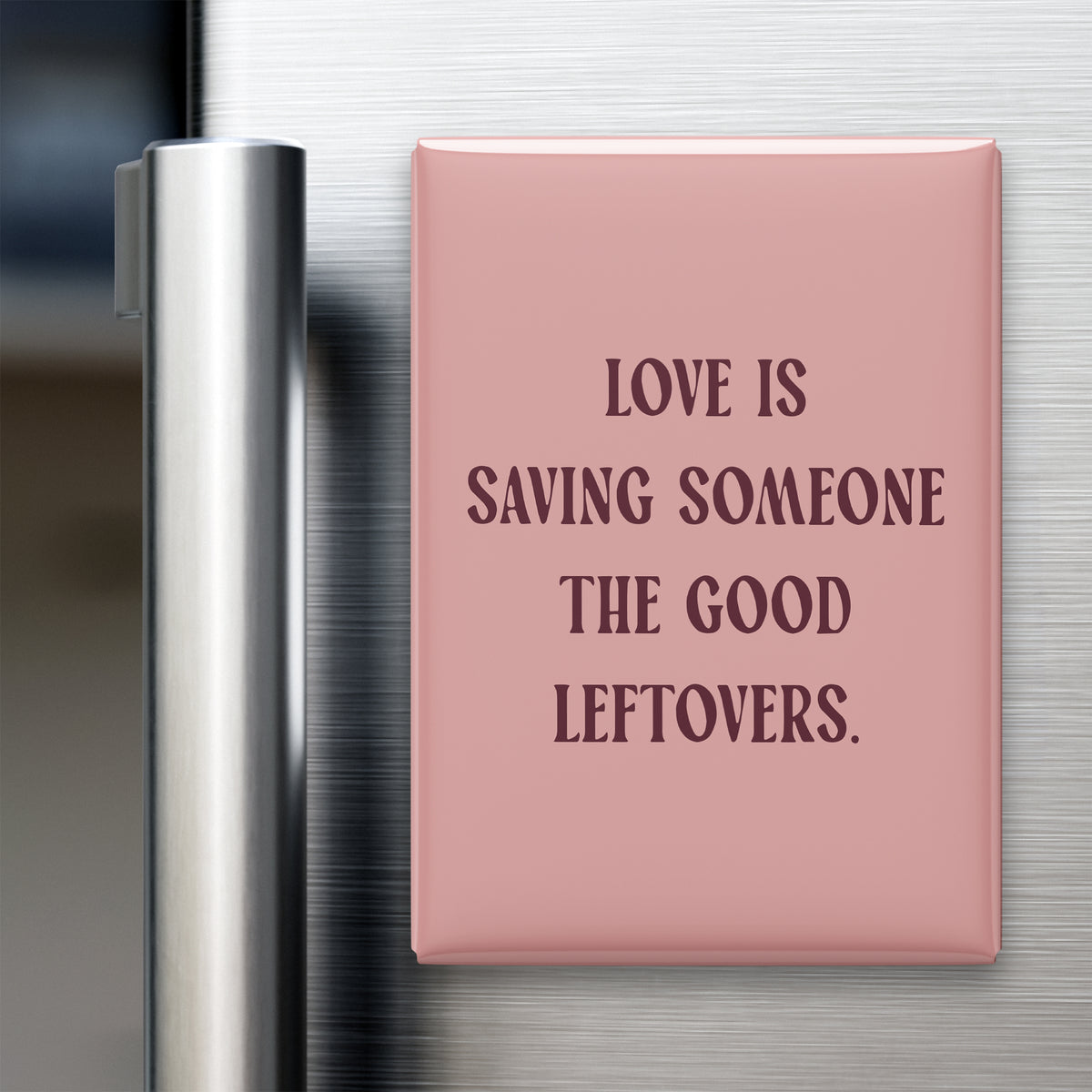 “Love is saving someone the good leftovers.” quote magnet displayed on a refrigerator