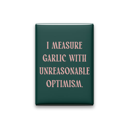 “I measure garlic with unreasonable optimism.” spruce quote magnet on white