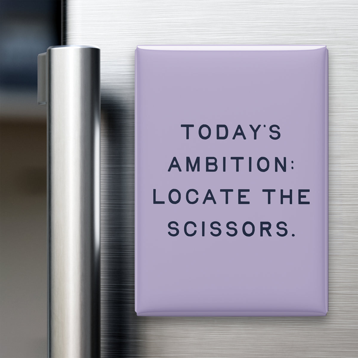 “Today's ambition: locate the scissors.” quote magnet displayed on a refrigerator
