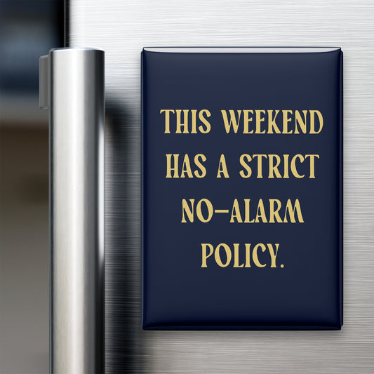 “This weekend has a strict no-alarm policy.” quote magnet displayed on a refrigerator