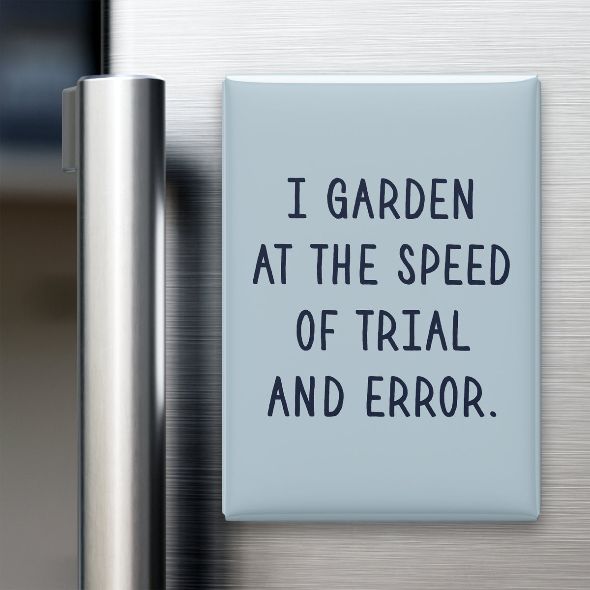 “I garden at the speed of trial and error.” quote magnet displayed on a refrigerator