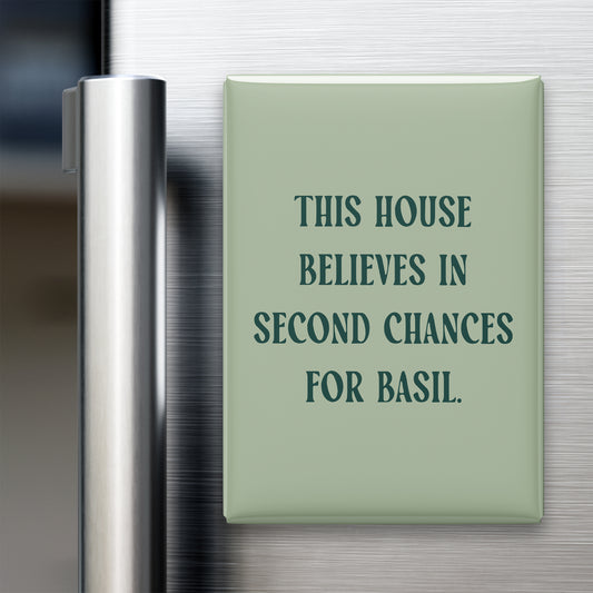 “This house believes in second chances for basil.” quote magnet displayed on a refrigerator