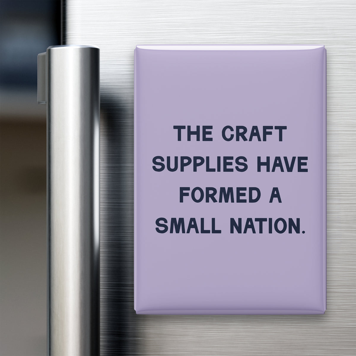 “The craft supplies have formed a small nation.” quote magnet displayed on a refrigerator
