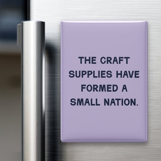 “The craft supplies have formed a small nation.” quote magnet displayed on a refrigerator