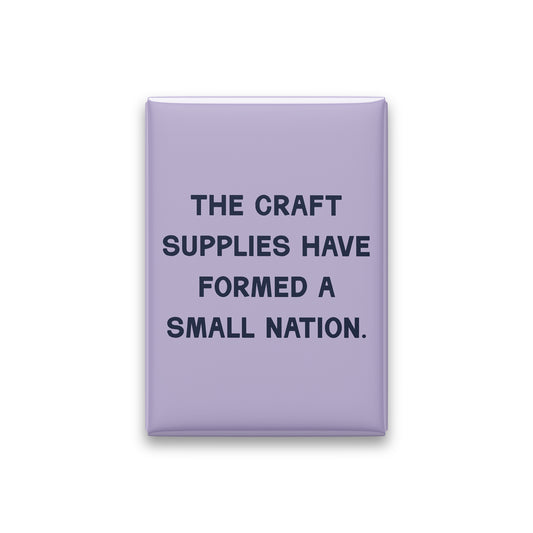 “The craft supplies have formed a small nation.” lilac quote magnet on white
