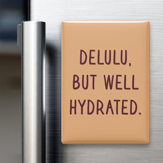 “Delulu, but well hydrated.” quote magnet displayed on a refrigerator