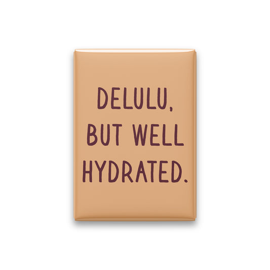 “Delulu, but well hydrated.” apricot quote magnet on white