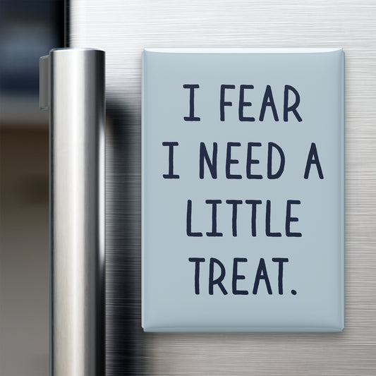 “I fear I need a little treat.” quote magnet displayed on a refrigerator
