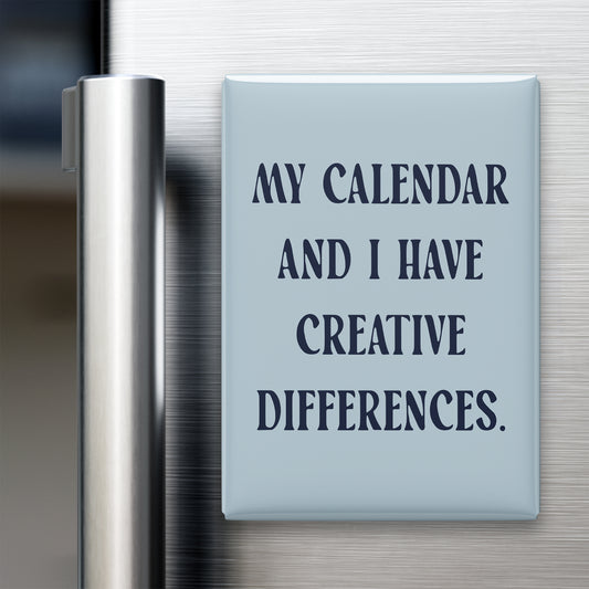 “My calendar and I have creative differences.” quote magnet displayed on a refrigerator
