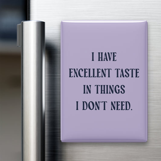 “I have excellent taste in things I don't need.” quote magnet displayed on a refrigerator