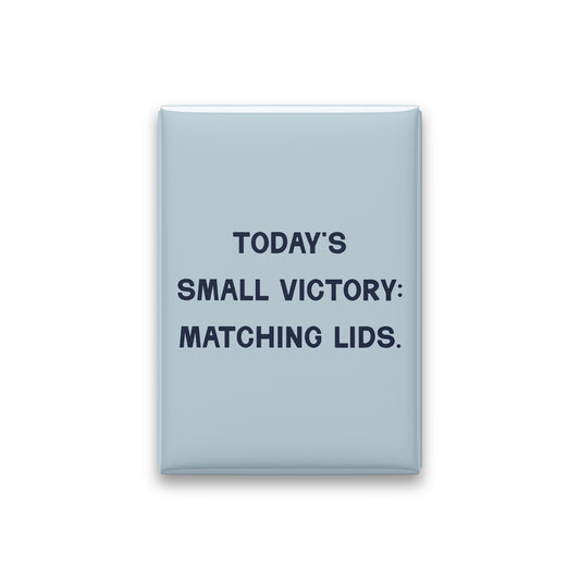 “Today's small victory: matching lids.” powder quote magnet on white
