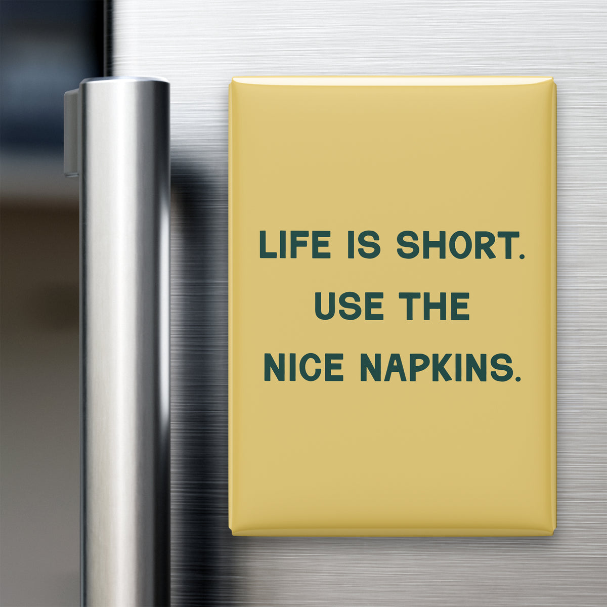 “Life is short. Use the nice napkins.” quote magnet displayed on a refrigerator
