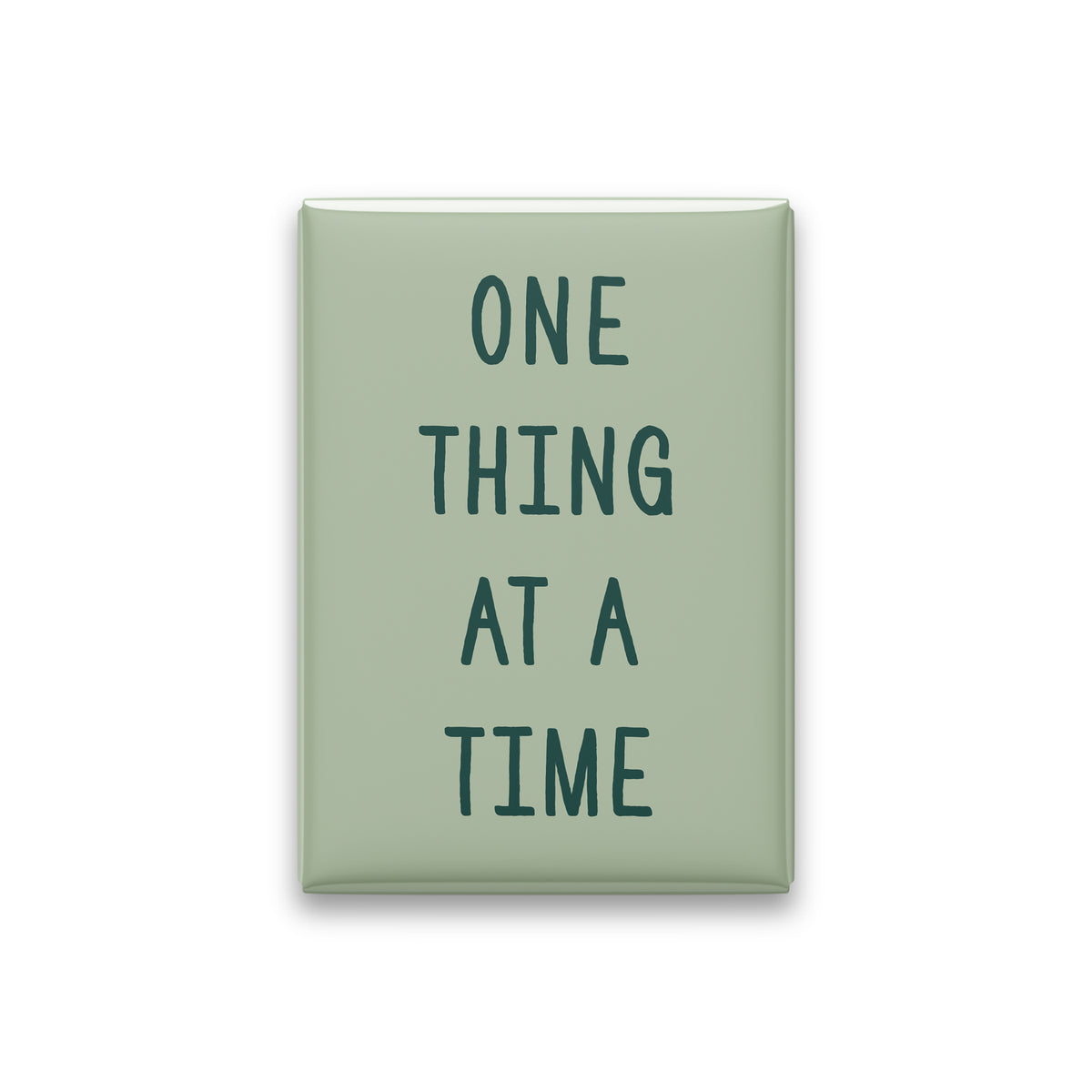 One Thing at a Time magnet in Spruce lettering on a Sage background, shown on white