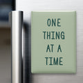 One Thing at a Time magnet in Spruce lettering on a Sage background, displayed on a refrigerator