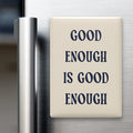 Good Enough Is Good Enough magnet in Midnight lettering on a Parchment background, displayed on a refrigerator