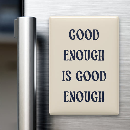Good Enough Is Good Enough magnet in Midnight lettering on a Parchment background, displayed on a refrigerator
