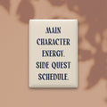 Main Character Energy. Side Quest Schedule magnet in Midnight lettering on a Parchment background, shown on a warm neutral background