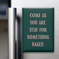 Come as you are. Stay for something baked. Small Talk magnet on a refrigerator