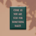 Come as you are. Stay for something baked. Small Talk magnet on a warm neutral background