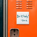 a locker with a sign that says "Do it lady! - Chit" written on it.