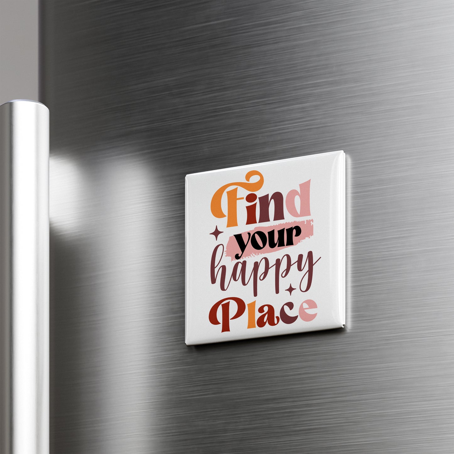 A white square magnet with the text "Find your happy place" on it is attached to a metallic surface.