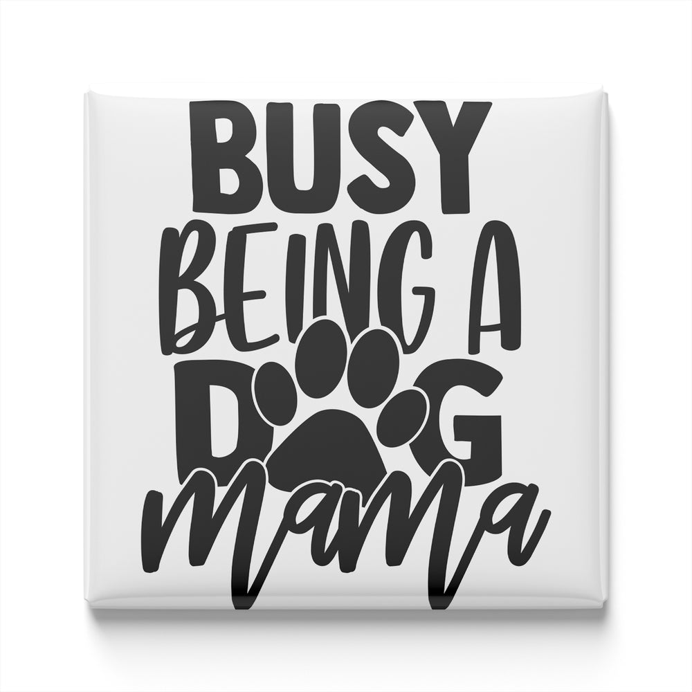 the text "BUSY BEING A DOG MAMA" in a stylized font, with a paw print design incorporated into the text.