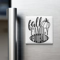 A refrigerator door with a magnet that says "fall family football" in a stylized font.