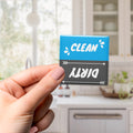 A hand holding a blue and black sign with the text "CLEAN" and "Dirty" written on it.
