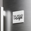 a white square magnet with the text "THE ANSWER IS NOPE" written on it.