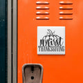 a close-up of an orange surface with a white sign that reads "My first Thanksgiving" in a stylized font.