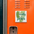 a sticker with a humorous text on an orange surface, which appears to be a locker or a storage unit.