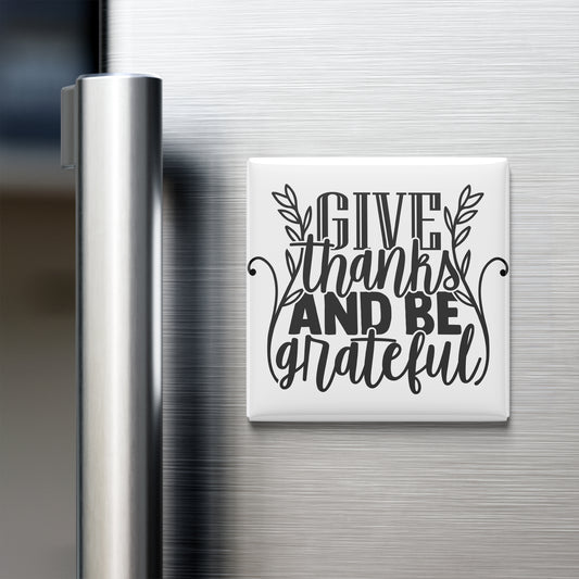 A white refrigerator magnet with the text "GIVE thanks AND BE grateful" written on it.
