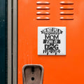 a sticker with the text "I'M NOT LIKE A REGULAR MOM I'M A DOG MAMA" on an orange surface, which appears to be a locker or a wall.
