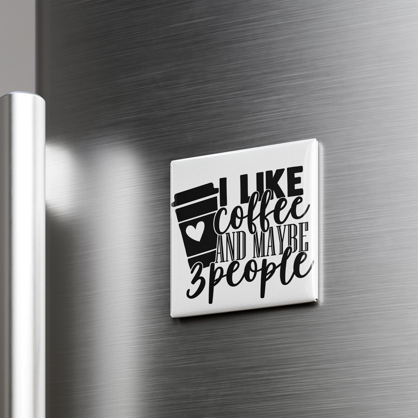 A white refrigerator magnet with the text "I LIKE coffee AND maybe 3 people" printed on it.
