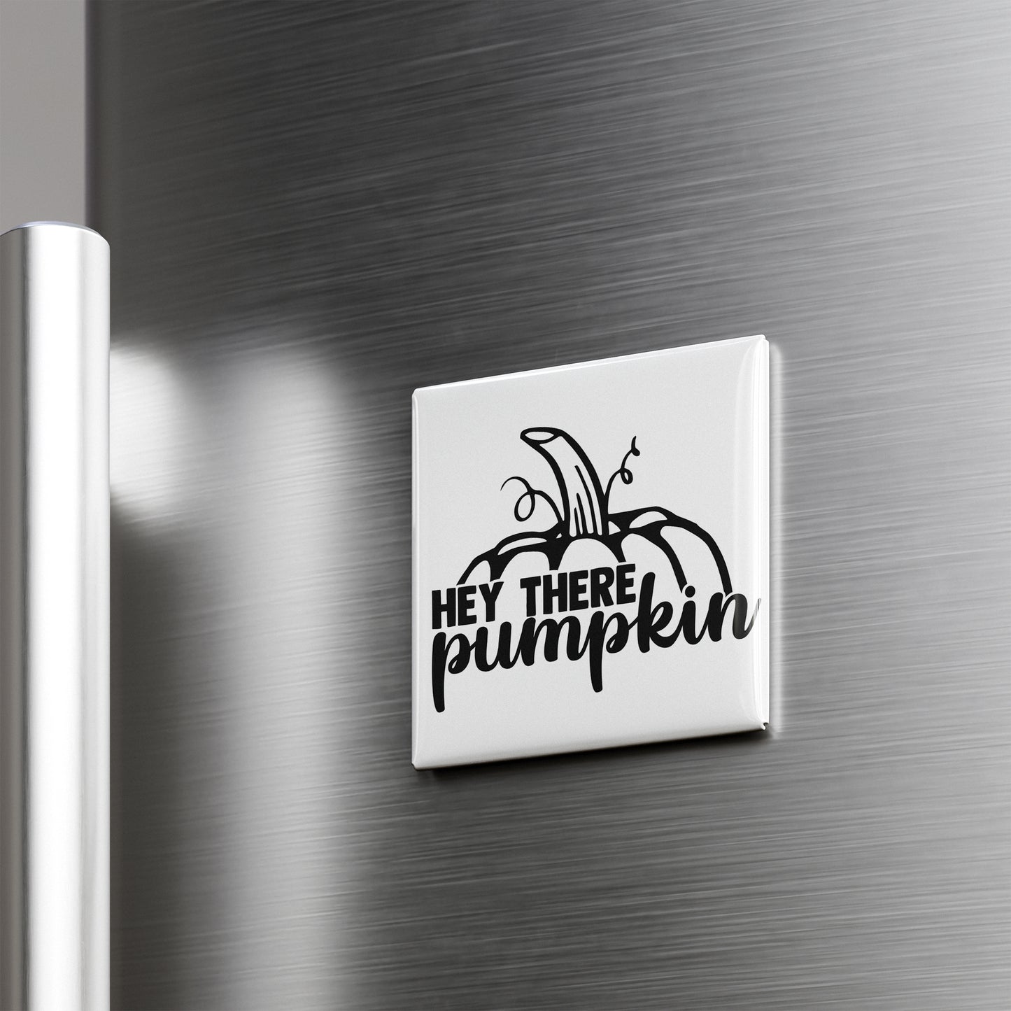 A white refrigerator door with a black and white sticker that says "HEY THERE PUMPKIN"