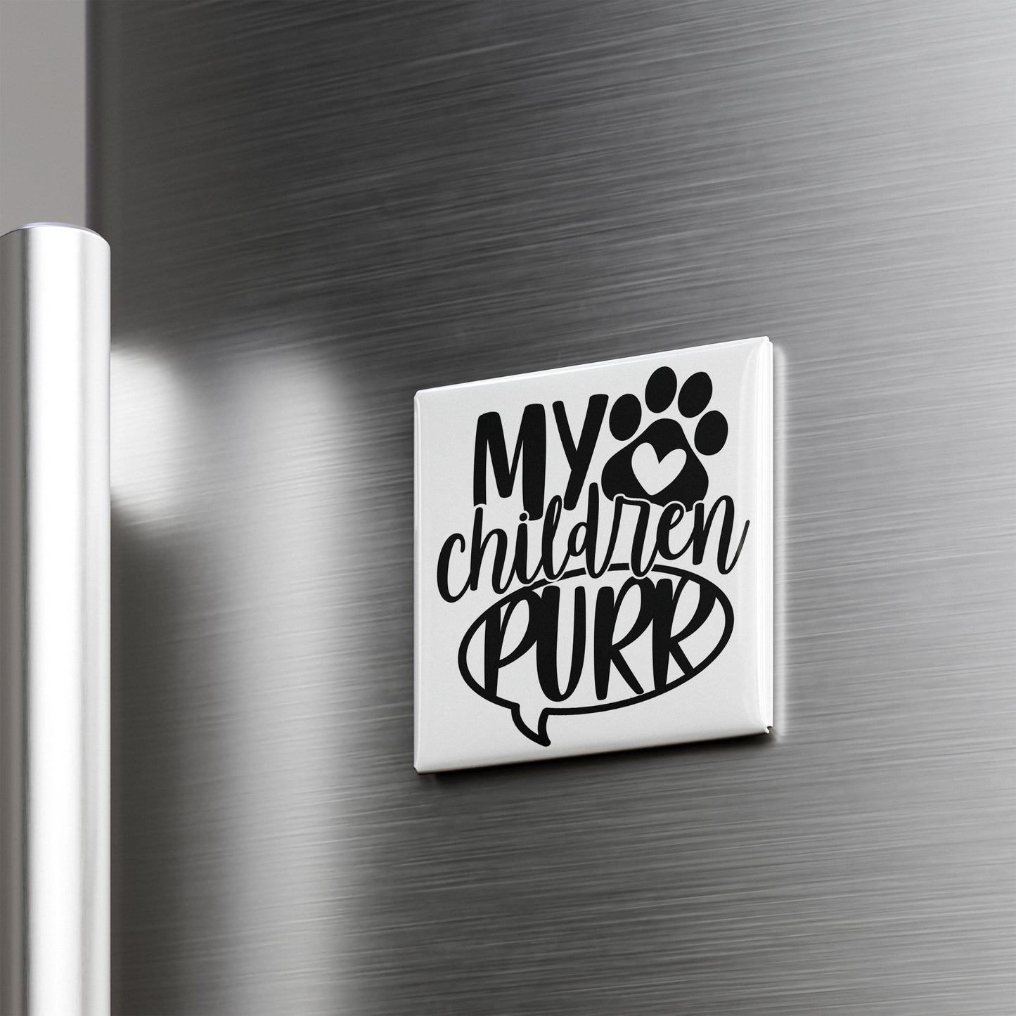 A refrigerator door with a sticker or decal that says "My children purr" along with a paw print symbol.