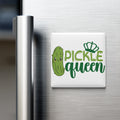 A refrigerator door with a magnet that says "Pickle queen" in a playful font.