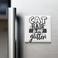 A white refrigerator magnet with the text "CAT HAIR IS MY GLITTER" printed on it.