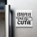 A refrigerator door with a white magnet that says "Pumpkin Patch Cutie" in black text.