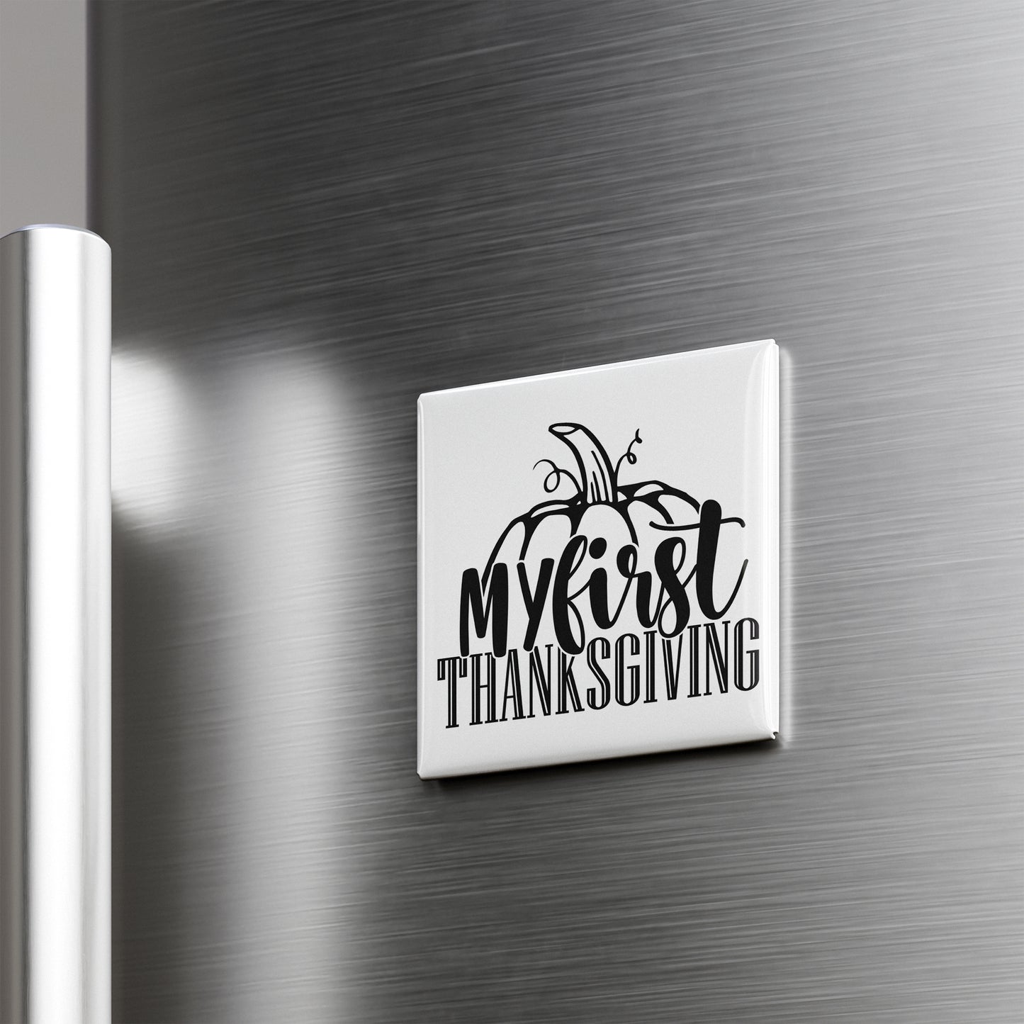 A white refrigerator magnet with the text "My first Thanksgiving" printed on it.
