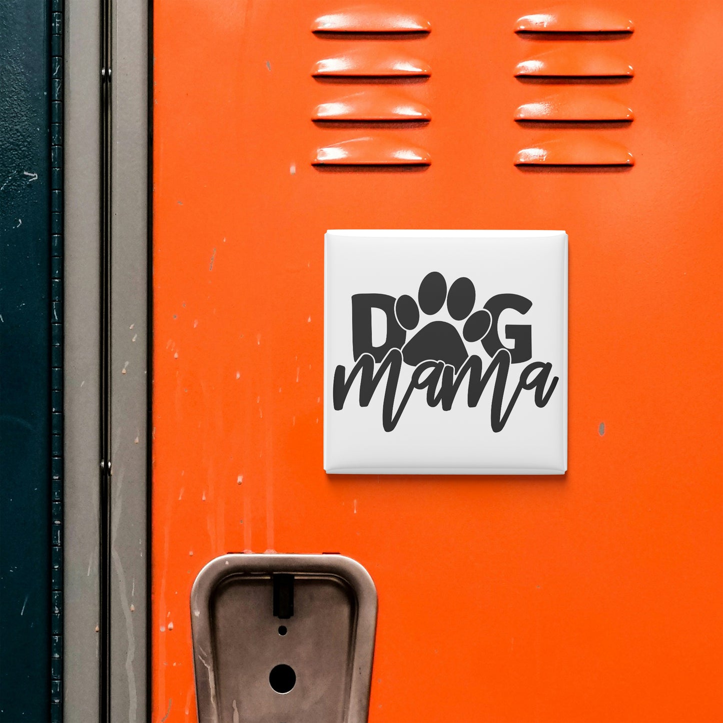 a close-up of an orange surface with a sticker or decal that says "dog mama" in bold black letters.