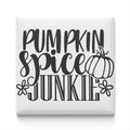the text "Pumpkin spice junkie" in a stylized font, with a pumpkin and flowers as decorative elements.