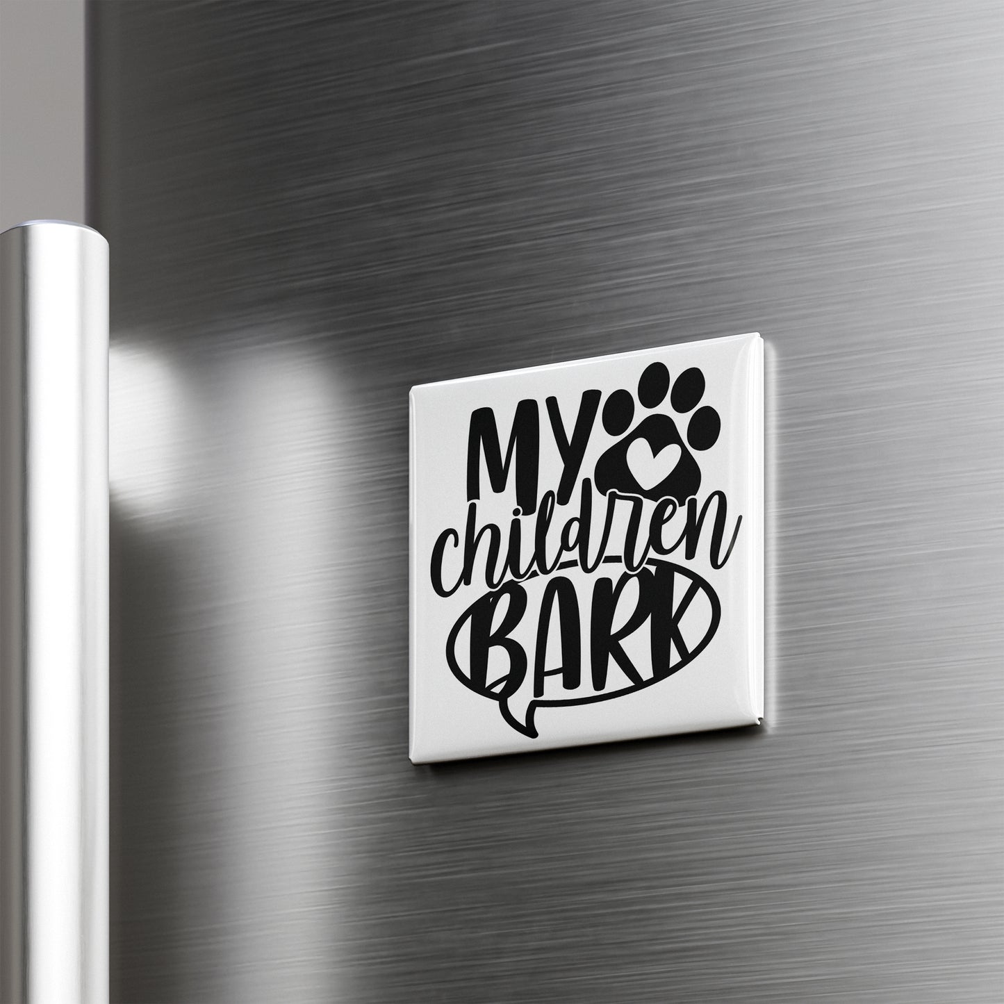A refrigerator door with a sticker or decal that says "My children bark" in a stylized font.