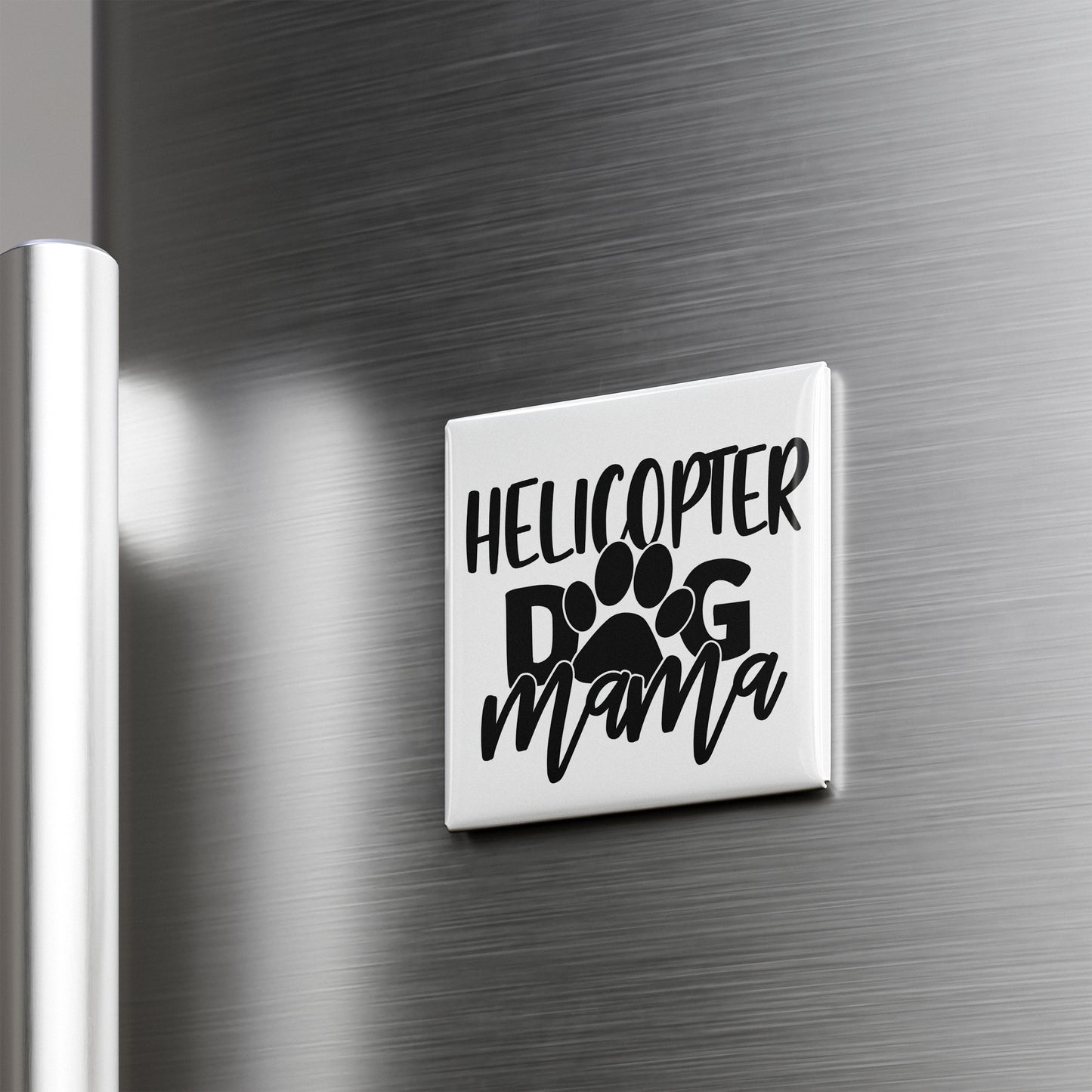 A refrigerator door with a sticker that says "HELICOPTER DOG MAMA" in black text.