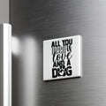 A white refrigerator magnet with the text "ALL YOU NEED IS LOVE AND A DOG" printed on it.